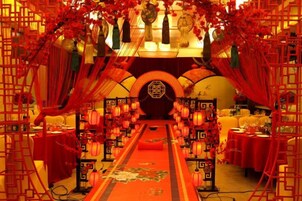 A corridor with red lanterns, traditional Chinese decorations, and a central archway.