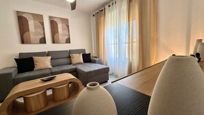 A modern living room with a grey sectional sofa, a wooden coffee table, and a large vase.