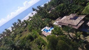 An aerial view of a resort with a swimming pool, palm trees, and a beach. - Glass lacquer! Jacuzzi on the sand with gourmet area! (BA)