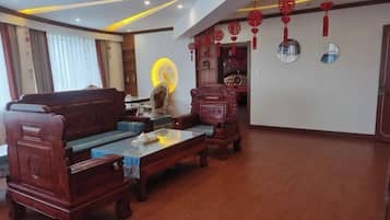 A traditional-style living room with a sofa, coffee table, and decorative items.