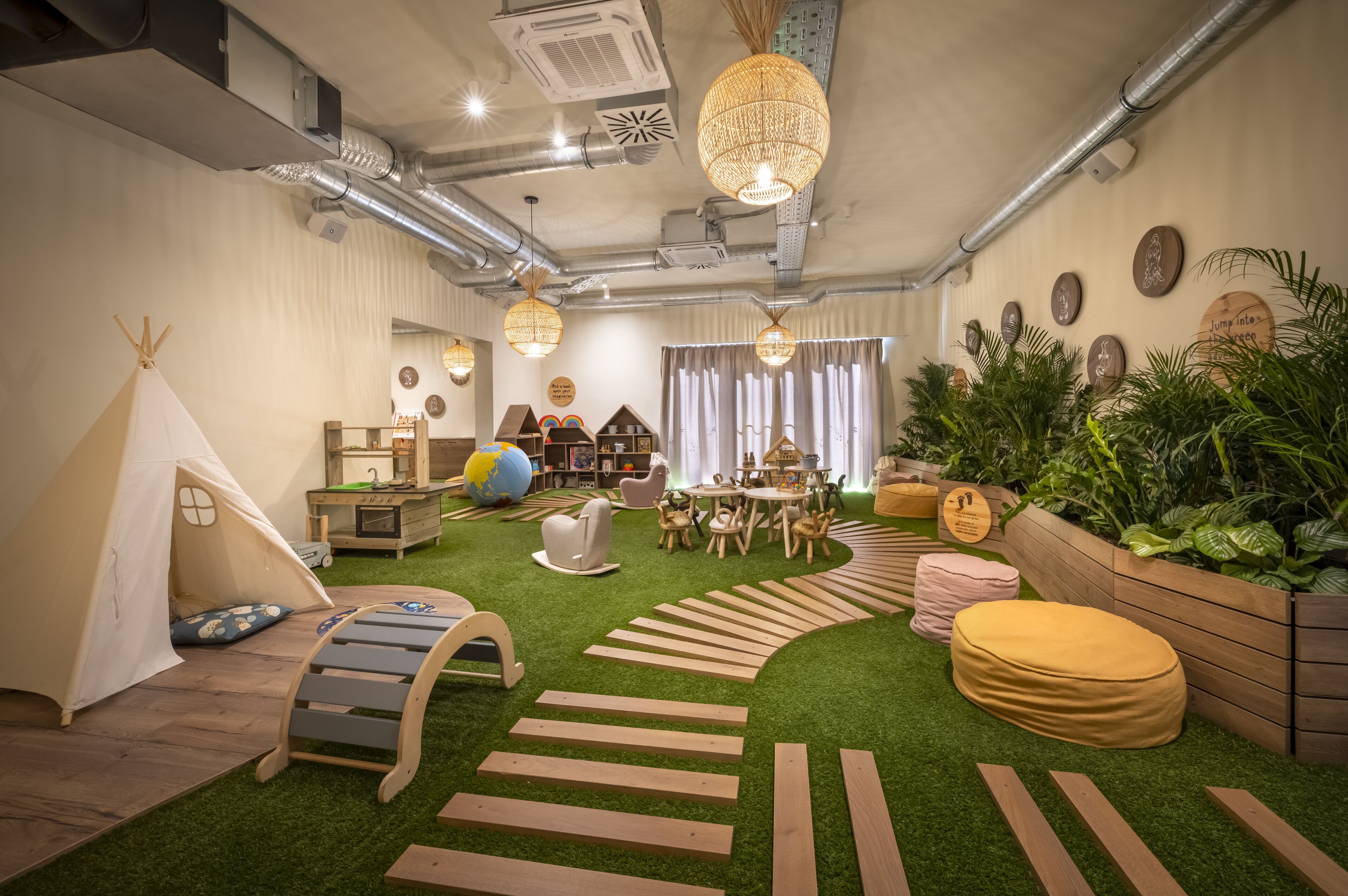 A cozy indoor space with a play area, a tent, a round table, and various seating options.