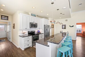 Enjoy cooking in this well-equipped kitchen with a large island and stainless steel appliances.