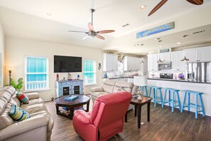 Relax in a cozy living space with a comfortable sofa, a stylish chair, and a flat-screen TV.