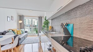 A modern apartment with a kitchen, dining area, and living room. - On the Water 2 -waterside Studio With Terrace Overlooking the Harbour (Brighton)