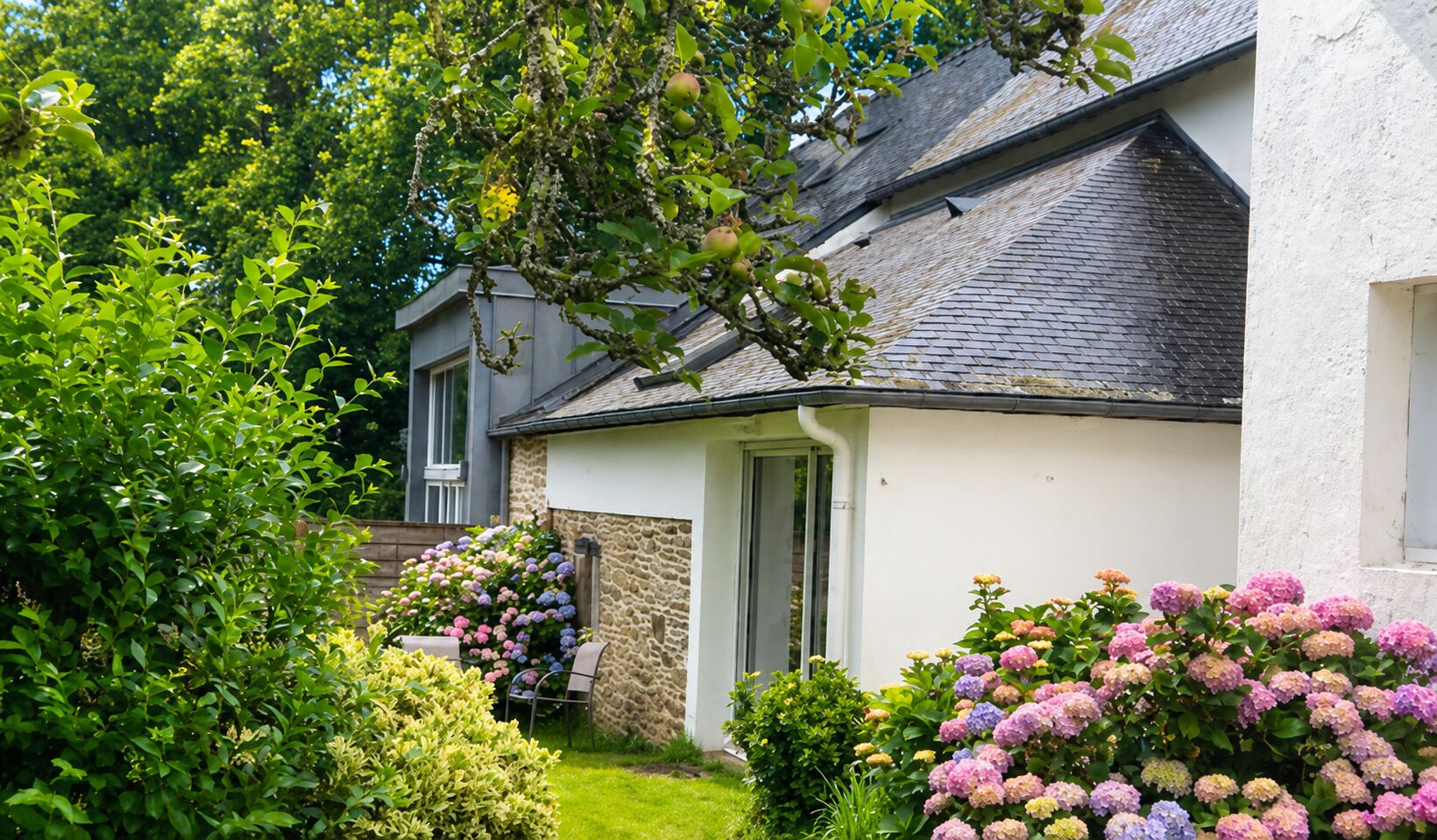 A house with a stone exterior, a door, and a window.