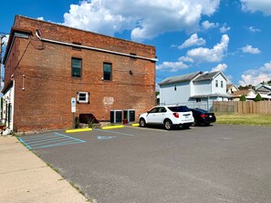 Guests can park their vehicles in the designated parking area adjacent to the building.