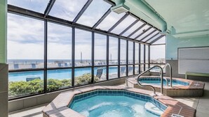 Una piscina en la azotea con vistas despejadas al océano y un puente.
