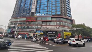 A multi-story hotel with a modern design, featuring a large glass facade and a prominent entrance. - Dongting Hotel (Nan County)