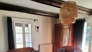 A living room with two brown leather sofas, a wooden coffee table, and a patterned blue armchair. - Family home in Provence with swimming pool (Noves)