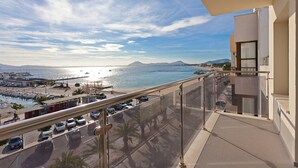 A balcony with a view of a marina, a beach, and a mountain in the distance. - Seafront Penthouse Marina Apartment (Port de Pollença)