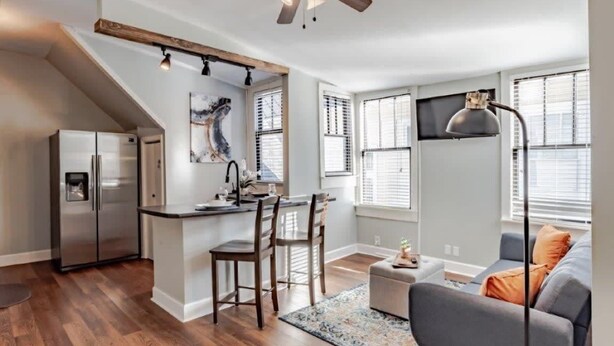 A modern kitchen with a central island, bar stools, and a ceiling fan. - 4 Units! Mins to Downtown&Dining - Dauphin Darling (Mobile)