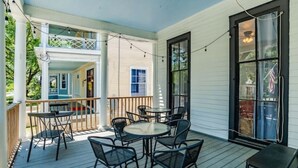 A covered porch with outdoor seating and a view of the house. - 4 Units! Mins to Downtown&Dining - Dauphin Darling (Mobile)