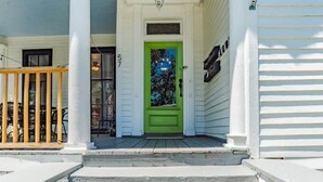 A house with a green door, white siding, and a porch with a wooden railing. - 4 Units! Mins to Downtown&Dining - Dauphin Darling (Mobile)