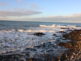 A rocky shoreline with waves crashing onto the rocks.