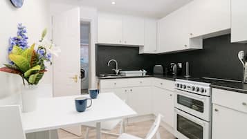 Fridge, electric kettle, toaster, cookware/dishes/utensils