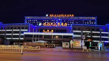 A multi-story building with illuminated signage and a prominent entrance.