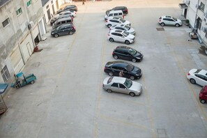 A parking lot with multiple cars parked in rows. - Jinhua Tian Hotel (Hanchuan)