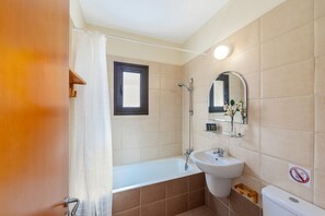 Bathtub, hair dryer, towels