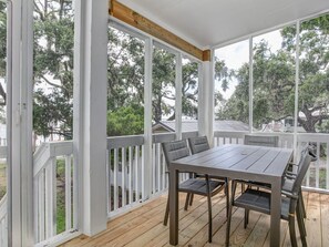 Enjoy dining or socializing in this shaded outdoor space surrounded by trees.