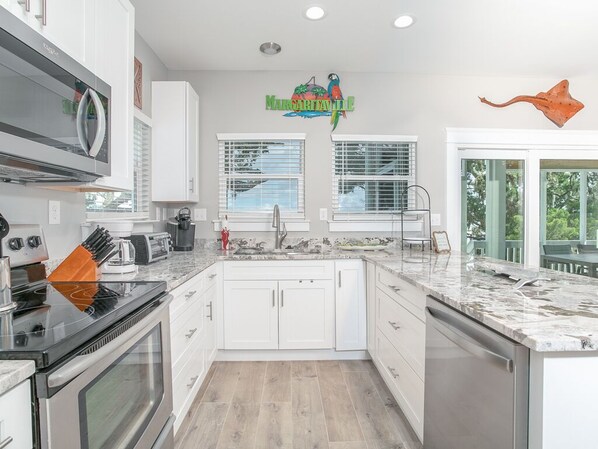 Enjoy cooking in this well-equipped kitchen with an oven, dishwasher, and stainless steel range hood.
