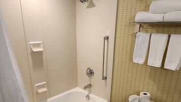 A bathroom with a bathtub, toilet, and a shower.