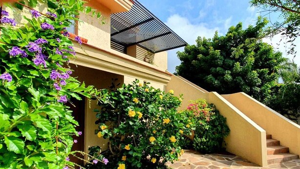 A two-story house with a stone staircase leading to the entrance. - Villas San Ángel (Departamento) (Ajijic)