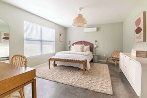 A bedroom with a bed, bedside tables, a desk, and a chair. - Boho House- A Rural Escape with Fire Pit, EV, WFH (Ithaca)