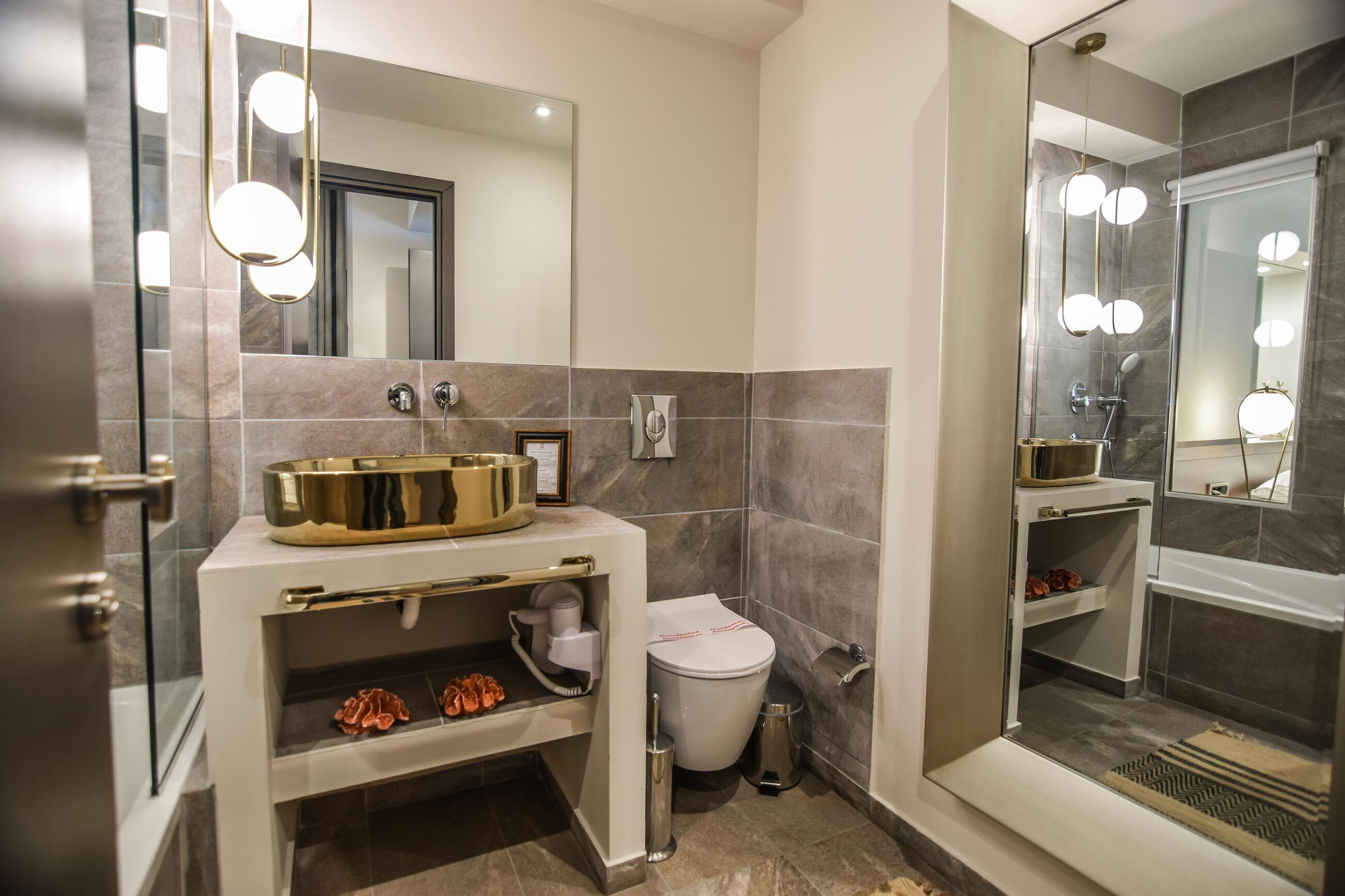 Un baño moderno con tocador, inodoro y zona de ducha.