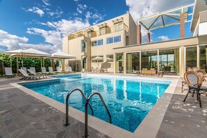 Seasonal outdoor pool, open 10:30 AM to 7:00 PM, pool loungers