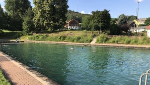 A swimming pool with a brick walkway and metal railings. - Climbing hut Saxon Switzerland ... Wander ... Climb ... Relax (Gossdorf)