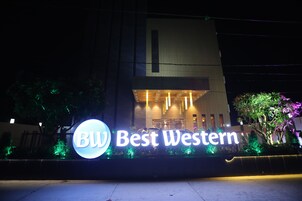 A hotel bejárata, melyen fényben úszó felirat hirdeti: „Best Western”.
