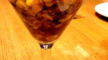 A dessert in a glass cup on a wooden table.