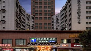 A hotel with a prominent sign, multiple floors, and a modern architectural design.