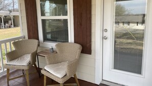 A porch with two wicker chairs and a small table, a sliding glass door, and a view of a yard. - Lakeview and direct access Boat Dock Lake Lewisville - Frisco/Little Elm
 (Frisco)