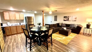 A compact living space with a kitchen, dining area, and seating area.