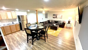 A compact living space with a kitchen, dining area, and a living room.