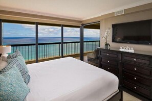 Enjoy ocean views from the balcony and unwind in the spacious bed.