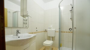 A bathroom with a sink, toilet, and shower. - Jela studio apartment (Rovinj)