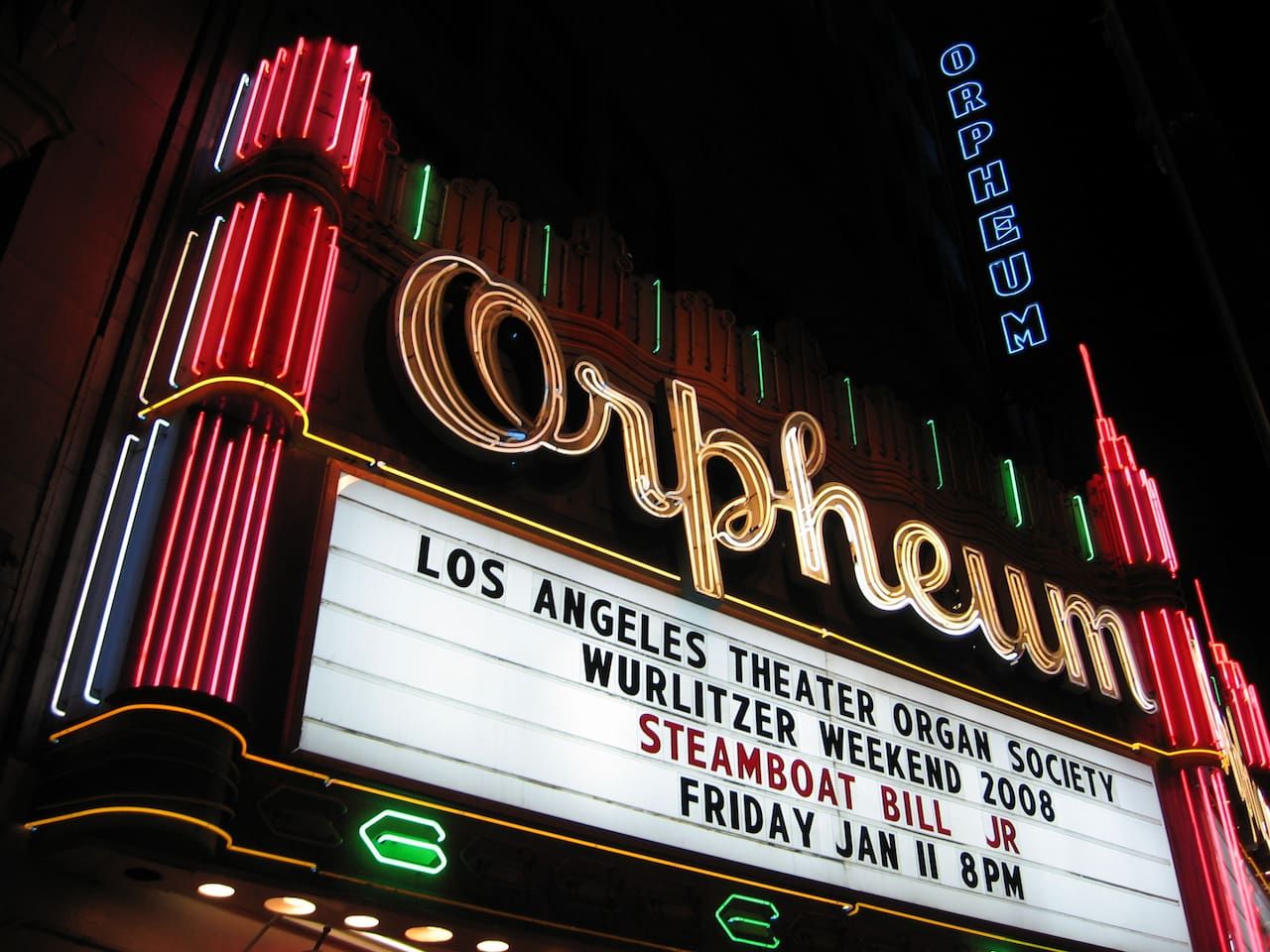 A theater marquee with the name 'Orpheum' and details of an event including the Los Angeles Theater Organ Society, Wurlitzer Weekend 2008, Steamboat Bill Jr., and the date Friday, Jan 11 at 8 PM.