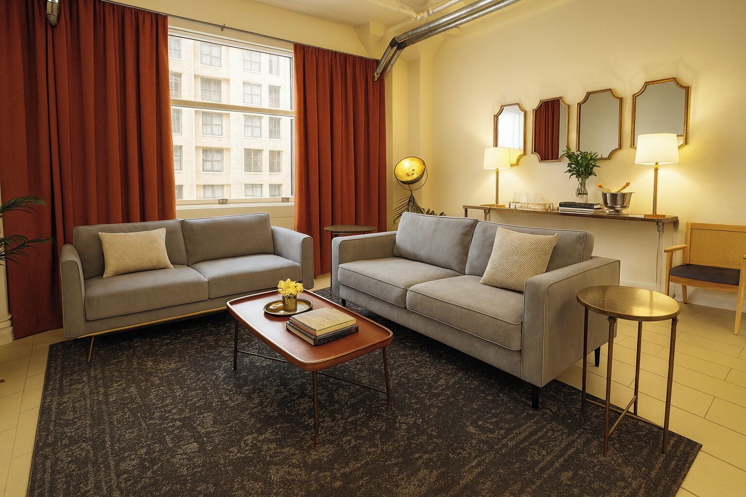 A living room with two sofas, a coffee table, a lamp, and a small side table.