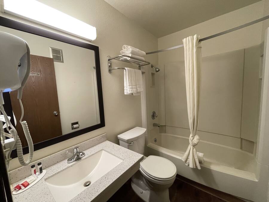 A bathroom with a sink, toilet, and shower.