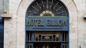 The exterior of Hotel Gillow with a prominent arched entrance and a decorative metal sign. - Hotel Gillow (Mexico City)