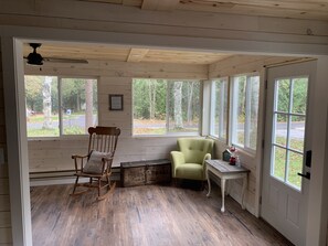 Relax in this charming room with a rocking chair and armchair, perfect for unwinding near the window.