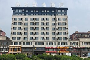 A multi-story hotel building with a flat facade and numerous windows.