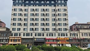 A multi-story hotel with a flat facade, numerous windows, and a sign at the top. - Super 8 Hotel Select Panjin Liaodongwan New Zone Binhai Avenue (Panjin)