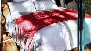 A bed with white linens and a red blanket, wooden walls, and a window with a view of trees. - The World of Echozellia - Loft Z (Saint-Germain-des-Champs)
