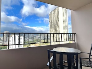 Enjoy the city view from this balcony with a round table and two chairs.