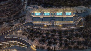 An aerial view of a modern building with multiple swimming pools, surrounded by a landscaped area with pathways. - Brand new villa in Falasarna★Seaview★Infinity pool (Phalasarna)
