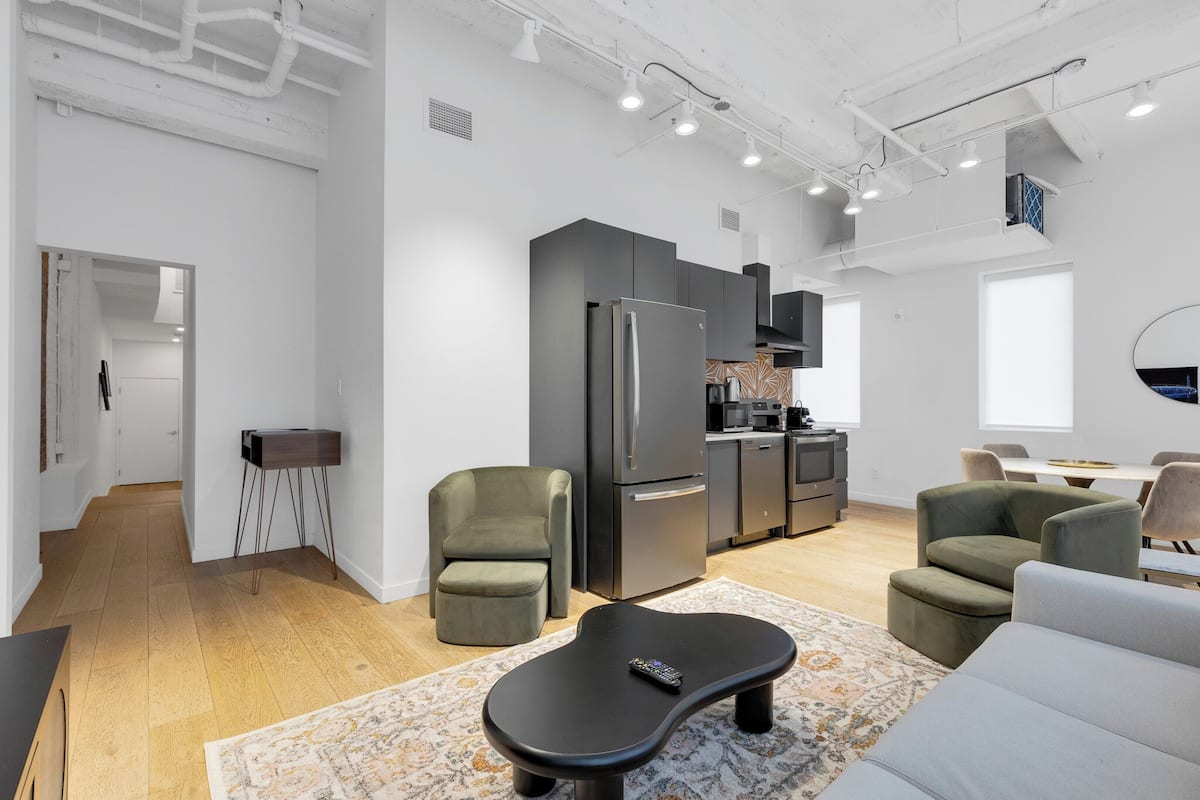 A modern apartment with a kitchen, dining area, and living room.