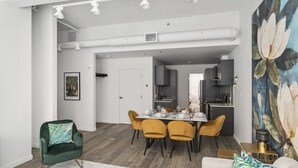 A modern living room with a dining area and kitchen.